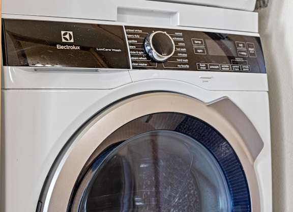 A front load washing machine with the door open.