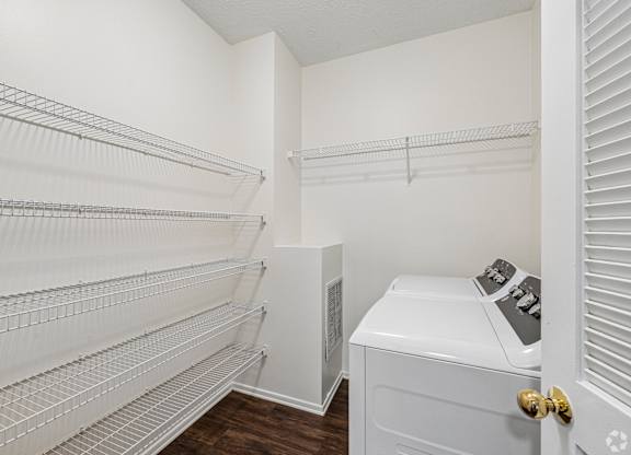 A white laundry room with a washer and dryer.