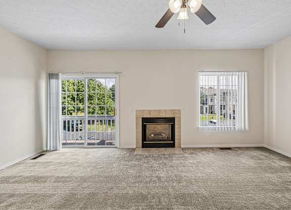 A room with a fireplace and a ceiling fan.