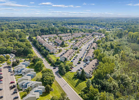 A bird's eye view of a residential area with houses and cars.