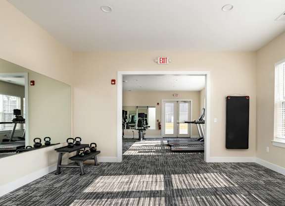 Spacious fitness center with mirror at Hathaway Meadows, Farmington, NY