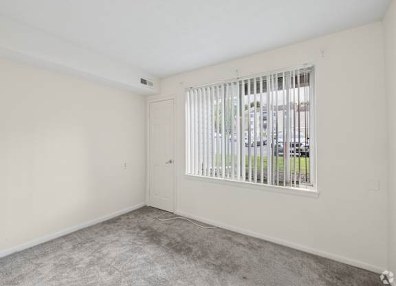 A room with a window and a door.