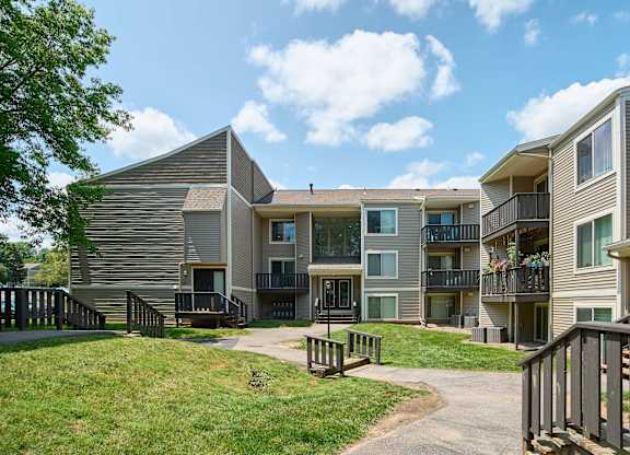 Apartment complex with a walkway between the buildings.