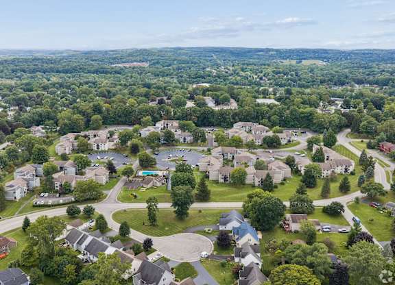 A bird's eye view of a residential neighborhood with houses and trees.
