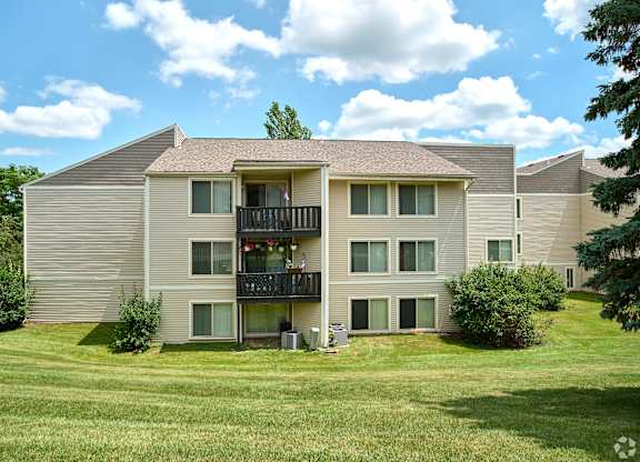 A large apartment complex with a balcony on the second floor.