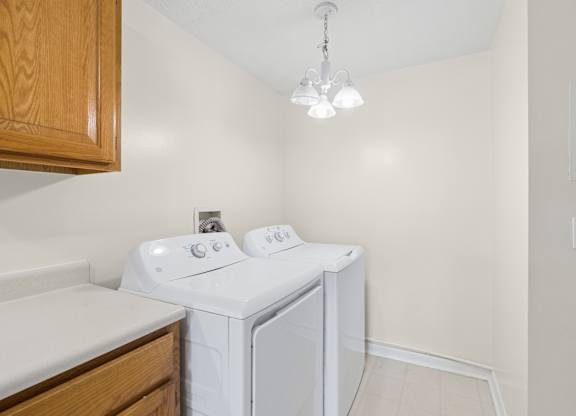 A small laundry room with a washer and dryer.