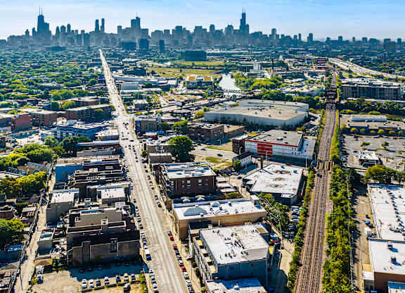 A cityscape with a highway running through the middle of a residential area.
