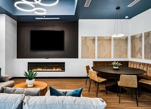 A modern living room with a fireplace and a television.