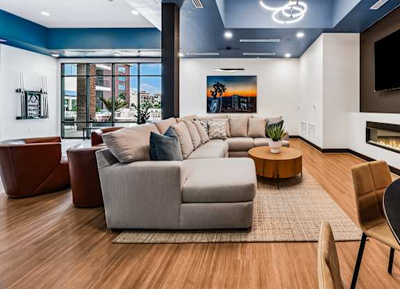 A modern living room with a fireplace and a large couch.