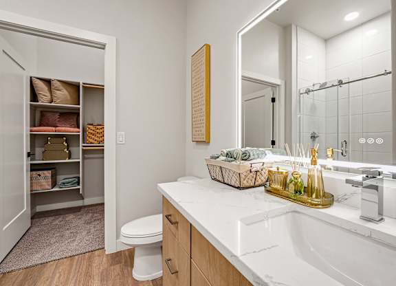 A bathroom with a white sink and a toilet.