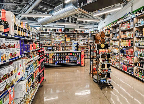 A liquor store with a variety of bottles on the shelves.