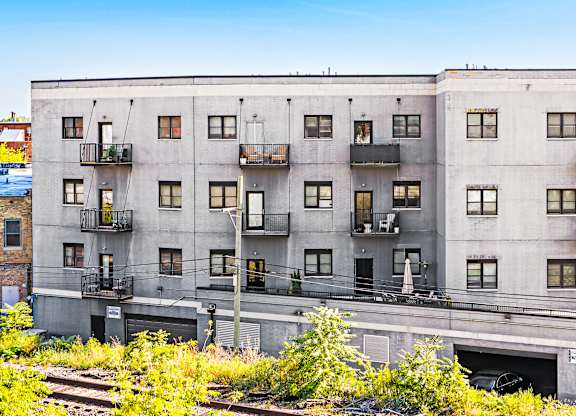 A large concrete building with many windows and balconies.