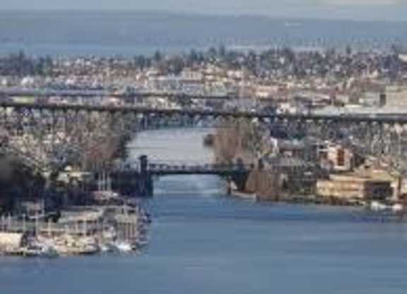 A river flows through a city with a bridge crossing it.