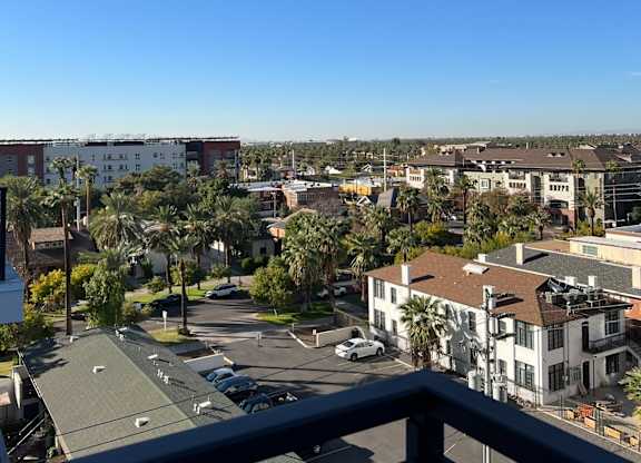 a view of the city from the balcony of a condo
