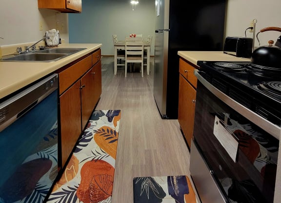 a kitchen with a stove and a sink and a table