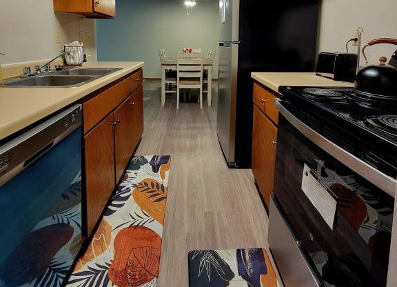 a kitchen with a stove and a sink and a table