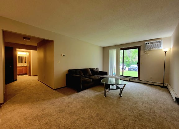 a living room with a couch and a glass coffee table