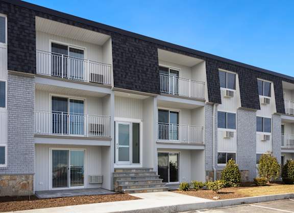 Building with balconies and a sidewalk at 151 Ocean Road LLC, Rhode , 02882