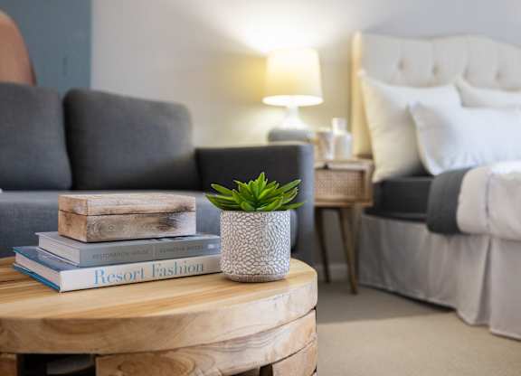 Stylish bedroom lighting with comfortable seating at 151 Ocean Road LLC, Narragansett, Rhode