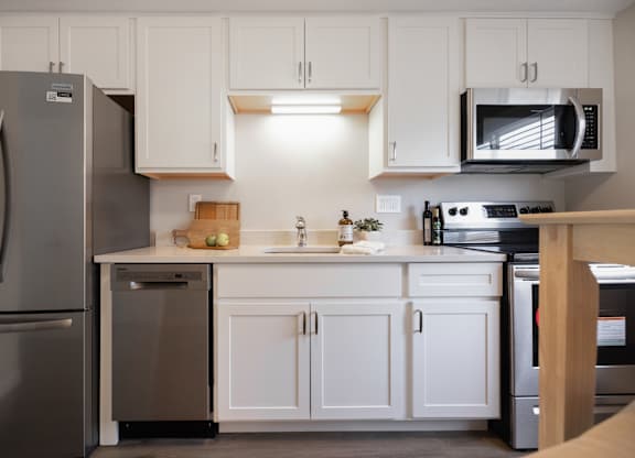 Modern Kitchen With White Cabinet and a marble counter top at 151 Ocean Road LLC, Rhode , 02882