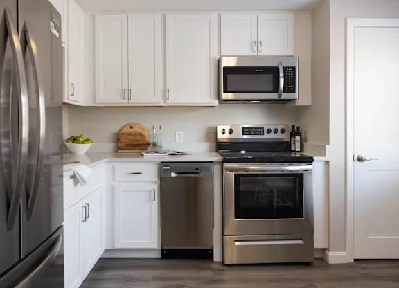 Kitchen with white cabinets and a stainless steel appliances at 151 Ocean Road LLC, Narragansett, RI, 02882