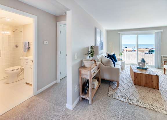 Carpeted living room with wide windows at 151 Ocean Road LLC, Narragansett, RI, Rhode , 02882