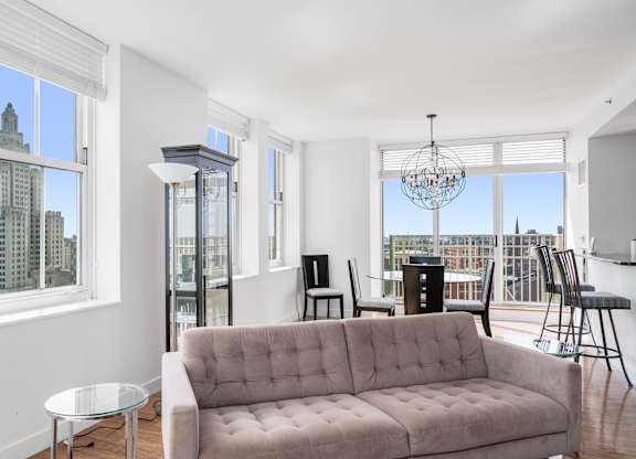 A living room with a couch, chairs, and a chandelier at Residences Providence, Providence, 2903