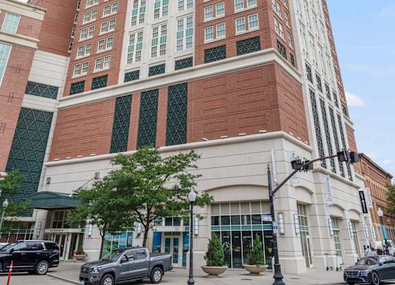 A tall red and white building with a clear blue sky in the background at Residences Providence, Providence, 2903