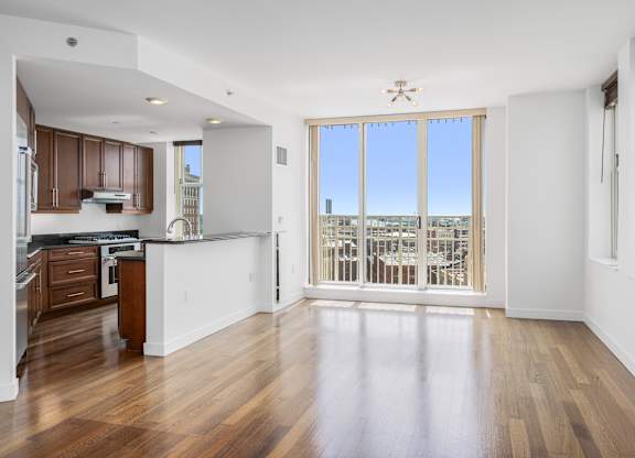 A spacious kitchen with wooden floors and a large window overlooking the city at Residences Providence, Providence, 2903