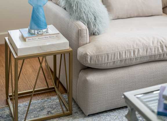A blue lamp sits on a table next to a couch at Residences Providence, Providence