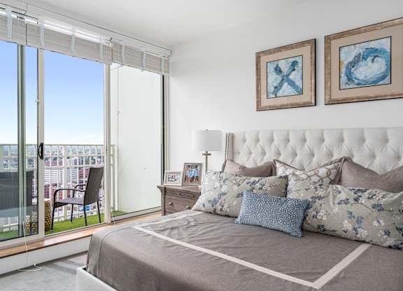 A bedroom with a large bed and a view of the city at Residences Providence, Rhode Island 2903