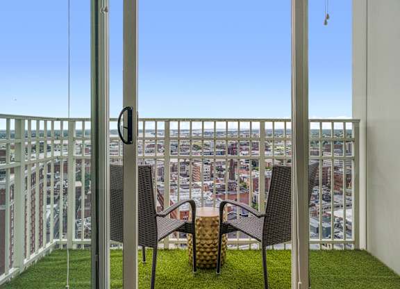 A balcony with two chairs and a table at Residences Providence, Providence