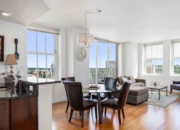 A modern kitchen with a dining table and chairs at Residences Providence, Providence, RI