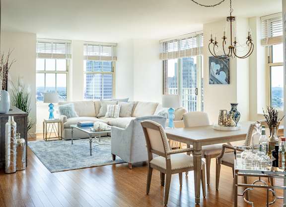 A living room with a white couch and a wooden table at Residences Providence, Providence, 2903