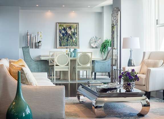 A living room with a white couch, a green vase, and a coffee table at Residences Providence, Providence, RI 2903