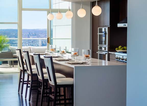 A modern kitchen with a long table and chairs at Residences Providence, Providence