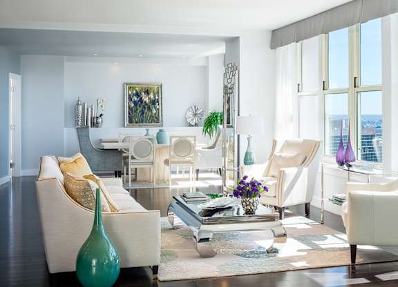 A living room with white furniture and a view of the city at Residences Providence, Providence, 2903