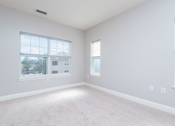 Drum hill one bedroom apartment bedroom with plush carpeting and large windows