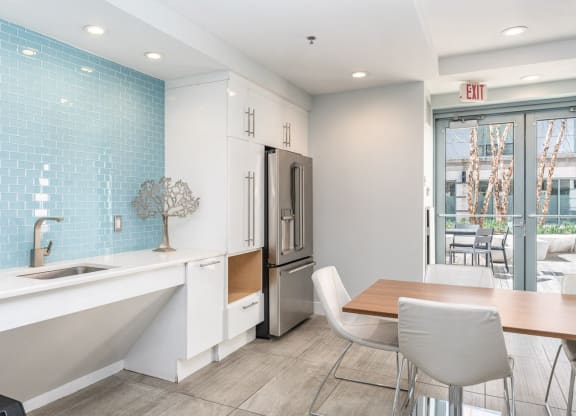 50 WB community space with a kitchen and dining area with a table and chairs