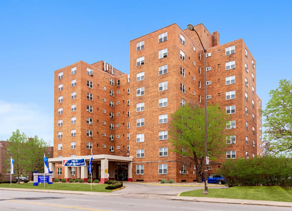 a tall brick building on the corner of a street