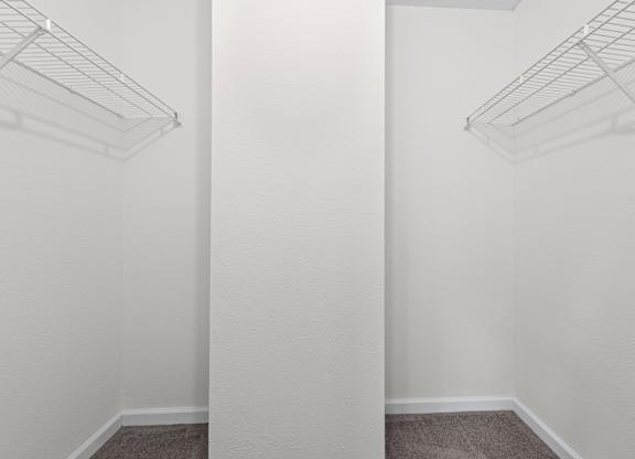 Two empty wire shelves are mounted on the wall.