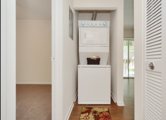 A laundry room with a washer and dryer at Aqua Bay Apartments in Naples, FL 34116
