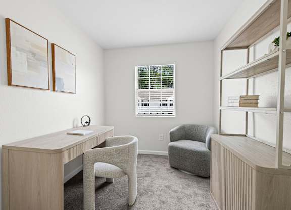 A room with a desk, chair, and bookshelf.