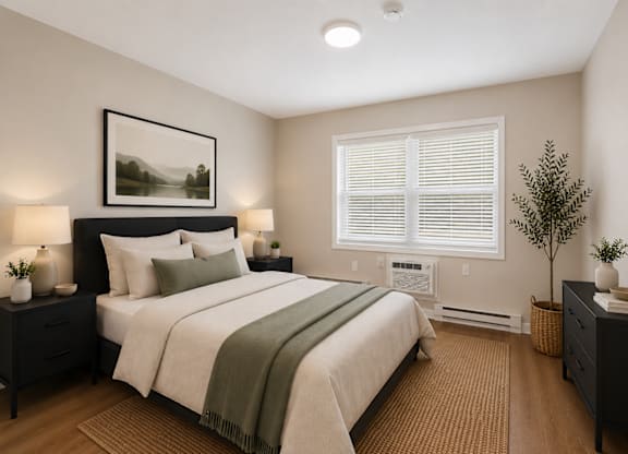 A bedroom with a large bed, two nightstands, and a framed picture on the wall.