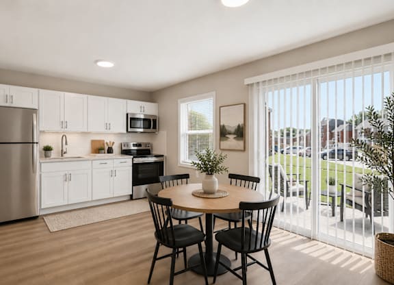 A modern kitchen with a dining table set for two.