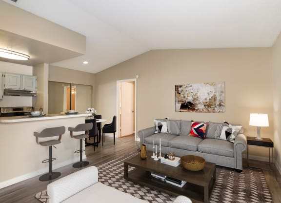 a living room with a couch and a coffee table at Aqua Bay Apartments in Naples, FL 34116