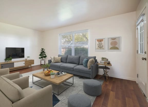 a living room with a couch and chairs and a tv