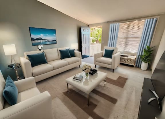 A living room with a white sofa, a white armchair, and a coffee table.