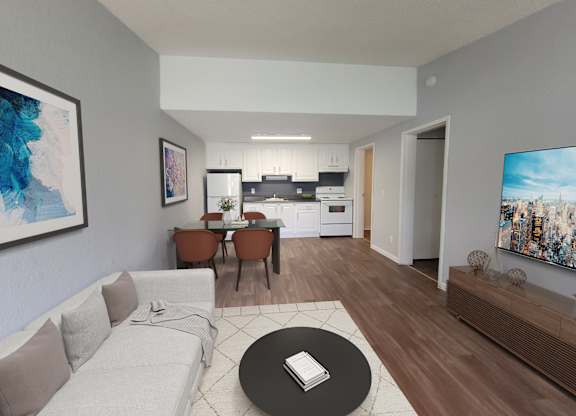 A modern living room with a white sofa, a black coffee table, and a painting on the wall.