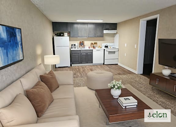 A modern living room with a couch, coffee table, and a kitchen in the background.